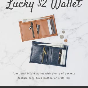 May include: Two open bifold wallets, one brown and one navy blue, with zippers and card slots. The text "Lucky $2 Wallet" is at the top. The wallets are on a white marble background. The text "Sallie Tomato" is at the bottom.