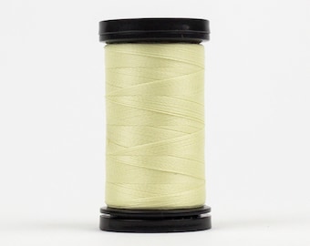 May include: A spool of pale yellow thread wound on a black plastic bobbin.