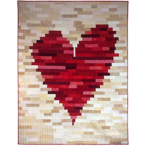 May include: A red pixelated heart quilt with a beige background. The heart is made up of many small squares of fabric in different shades of red.