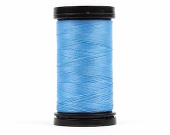 May include: A spool of light blue thread with black plastic caps on either end.