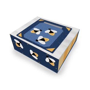 May include: A decorative box with a bee theme. The box has a navy blue background with white and yellow bees. The top has a navy blue inset with three bees. The sides of the box are white and yellow.