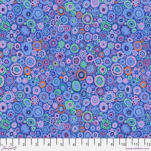 May include: A fabric with a repeating pattern of colorful, abstract shapes in shades of blue, pink, green, and orange. The design features various sizes of circular and floral-like forms. The fabric has a light blue background. The text "Free Spirit" is visible.