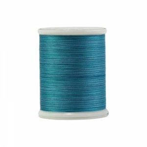 May include: A spool of teal blue thread.