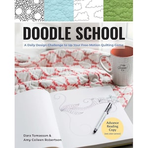 May include: A book titled "Doodle School: A Daily Design Challenge to Up Your Free-Motion Quilting Game" by Dara Tomasson & Amy Colleen Robertson. The book cover features a white mug with the text "Hola Gorgeous!" and a doodle design on a white page.