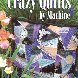 May include: A book titled Crazy Quilts by Machine by J. Marsha Michler, featuring a cover image of a square pillow with a patchwork design in shades of blue, purple, and black, decorated with white lace, embroidery, and a white butterfly motif.