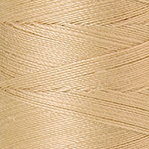 May include: A close-up of a spool of beige thread.