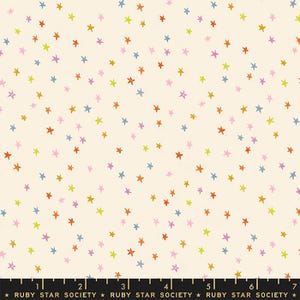 May include: Cream-colored fabric with a scattered pattern of colorful stars in shades of orange, green, blue, purple, and pink. The stars are of varying sizes and are evenly distributed across the fabric. The text "RUBY STAR SOCIETY" is at the bottom.