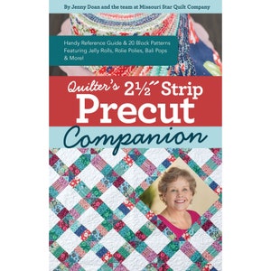May include: A book titled "Quilter's 2 1/2" Strip Precut Companion" with a colorful quilt pattern on the cover and a photo of a woman smiling. The book is by Jenny Doan and the team at Missouri Star Quilt Company. It features a handy reference guide and 20 block patterns, including jelly rolls, rolie polies, and Bali pops.