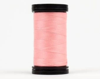 May include: A spool of pink thread with black plastic caps on either end.