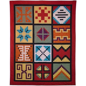 May include: A red quilt with a patchwork design featuring 16 different geometric patterns in various colors, including red, orange, yellow, green, blue, purple, and black.