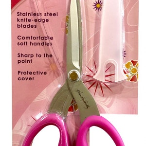 May include: Pink handled scissors with stainless steel blades and a protective cover. The packaging says "Karen Kay Buckley's Perfect Scissors" and "Large Multipurpose".