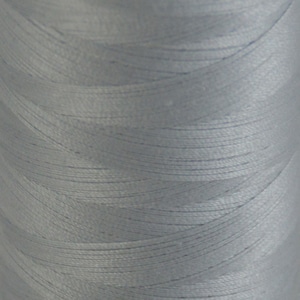 May include: A spool of light blue thread.