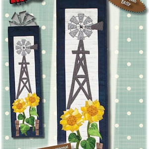 以下が含まれることがあります： 風車とヒマワリのデザインの布製壁掛け。サイズは15cm×56cmです。デザインには風車、黄色のヒマワリ、緑の葉が含まれています。スキルレベルは簡単です。「Windmill & Sunflowers」の文字が上部にあります。