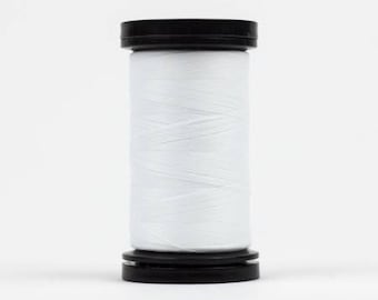 May include: A spool of white thread in a black plastic container.