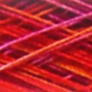 May include: Close-up of a red, orange, and purple yarn with a textured, woven look.