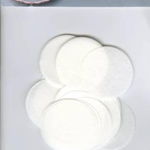 May include: A package of white, circular EPP iron ons. The package has the text "EPP iron ons" and a logo that says "hugs'n kisses". The iron ons are stacked on top of each other.
