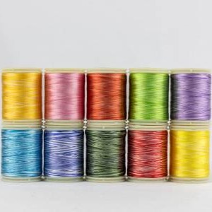May include: A collection of colorful spools of thread, arranged in two rows. The threads are in various colors, including yellow, pink, orange, green, and purple. The spools are on a white background.