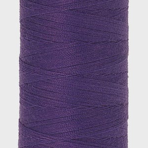 May include: A spool of purple thread with a red base and top. The thread is tightly wound, and the spool has the text "Mettler" and "No.100 500m/547yds". This thread is suitable for sewing and crafting projects.