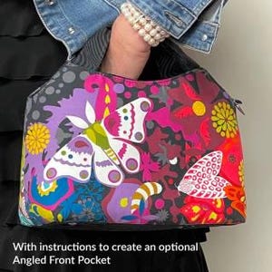 May include: The Hope Handbag, a colorful tote bag with a vibrant butterfly and floral design. The bag is held by a person wearing a denim jacket and a pearl bracelet. Finished size is approximately 11.5" x 9" x 5". Includes instructions for an angled front pocket.
