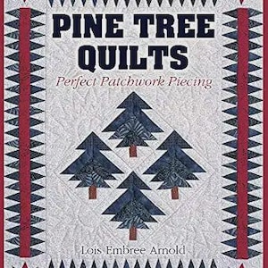 May include: A book titled PINE TREE QUILTS Perfect Patchwork Piecing by Lois Embree Arnold. The cover features a white background with a central pattern of four dark blue pine trees, framed by red and dark blue sawtooth borders and stars.
