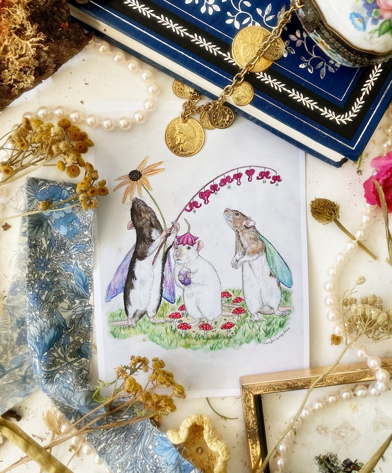 May include: A watercolor illustration of three rats wearing fairy wings and holding a flower. The rats are standing in a field with red mushrooms and a pink flower. The illustration is titled "In the spirit of joy".