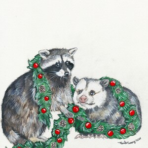 Print of a raccoon stands on his back legs crouching forward, holding a large green garlands of pine, pine cones, and red globe ornaments. To his left is an opossum sitting and smiling with the garland draped over his neck