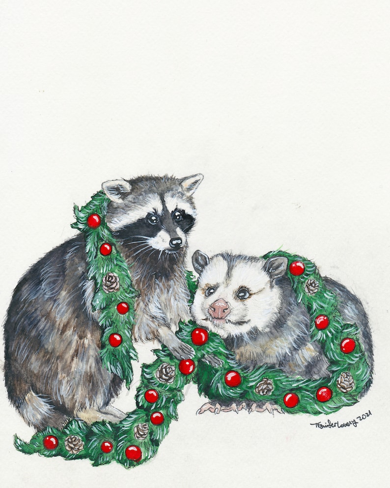 Print of a raccoon stands on his back legs crouching forward, holding a large green garlands of pine, pine cones, and red globe ornaments. To his left is an opossum sitting and smiling with the garland draped over his neck