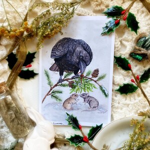 May include: A black crow perched on a snowy branch with green holly berries. Two small brown mice are on the ground below, one looking up at the crow and the other looking at the viewer. The image is a watercolor painting with a white background.