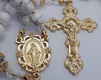 Handmade howlite and Czech crystal rosary beads.  Gold toned miraculous medal centre and crucifix.