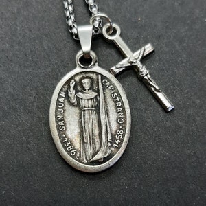 St Juan Capistrano | Stainless steel box chain with saint medal and crucifix.
