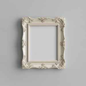 May include: A white ornate picture frame with a decorative, carved design. The frame is empty and ready for a photo or artwork.