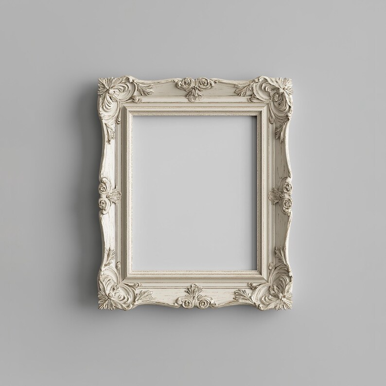 May include: A white ornate picture frame with a decorative, carved design. The frame is empty and ready for a photo or artwork.