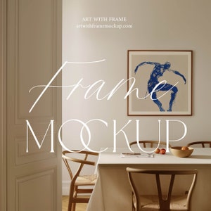 May include: A framed art print of a blue figure dancing, hanging on a beige wall above a dining table with two chairs. The text "Frame Mockup" is written in white cursive letters on the wall. The website address "artwithframemockup.com" is written in black text below the text "Art with Frame".