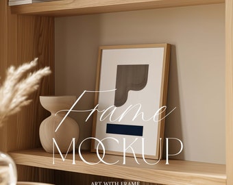 May include: A wooden shelf with a framed abstract art print featuring a brown and blue geometric design. The shelf is decorated with a vase and dried pampas grass.