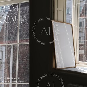 May include: A white frame mockup with a wooden frame, sitting on a windowsill. The frame is a smart object, meaning you can easily add your own artwork or design.