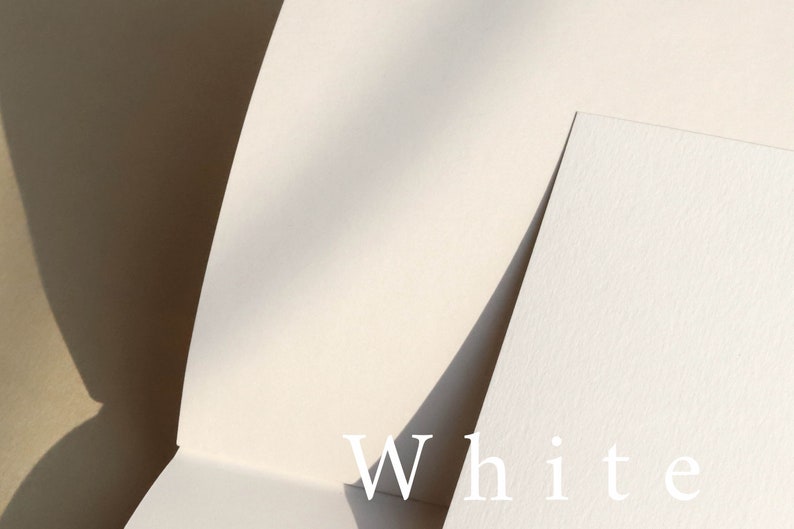 May include: Two pieces of white paper, one on top of the other, with the word "White" printed in white on the bottom piece of paper.