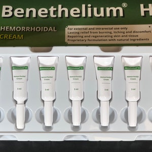May include: A white plastic tray containing eight individual tubes of hemorrhoidal cream labeled "Benethelium H Hemorrhoidal Cream 3 ml".