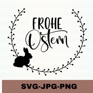 May include: Black and white silhouette of a bunny rabbit with a wreath of leaves and berries around it. The text "Frohe Ostern" is written in a decorative font.