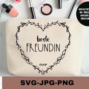 Pode incluir: Uma necessaire de lona branca com um design de coração preto e o texto "beste FREUNDIN ever".