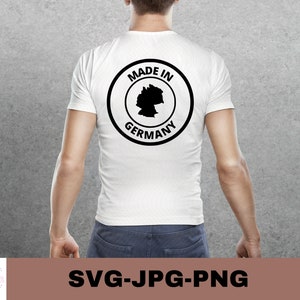 May include: White t-shirt with a black circle graphic that says "Made in Germany" with an outline of the country inside the circle.