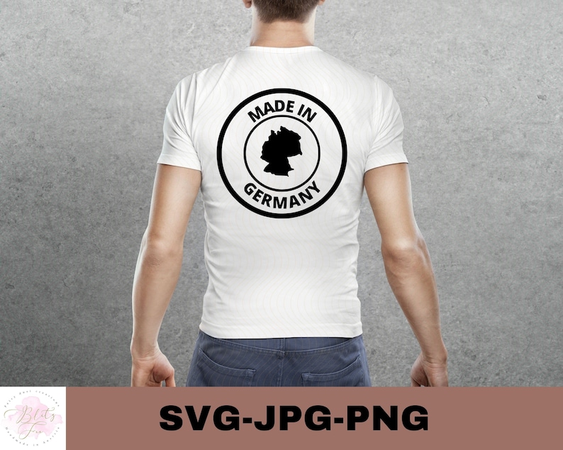 May include: White t-shirt with a black circle graphic that says "Made in Germany" with an outline of the country inside the circle.