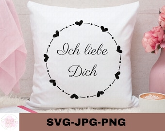 May include: White pillow with black text that reads "Ich liebe Dich" surrounded by a circle of black hearts.