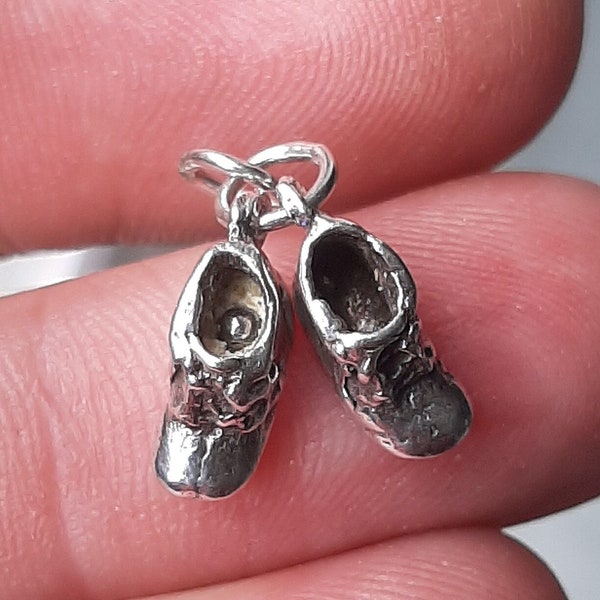 A silver pair of boots pendant charm