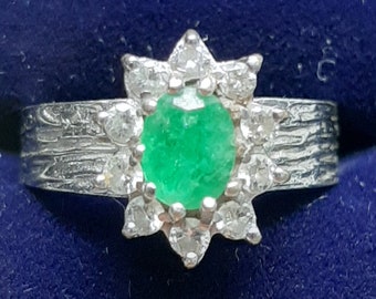 A vintage 18ct white gold emerald and diamond ring