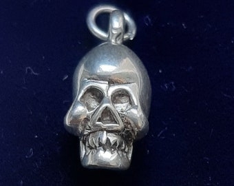A silver skull pendant