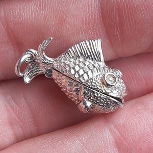 A silver fish pendant charm