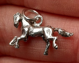 A silver prancing horse pendant charm