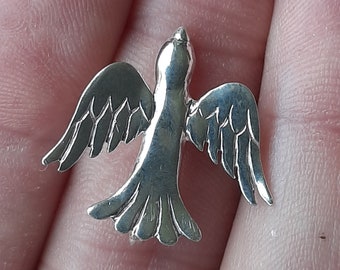 A silver bird pendant