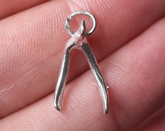 A silver wishbone pendant charm