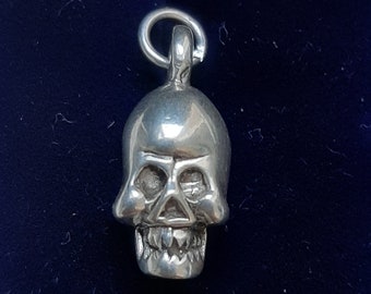 A silver skull pendant